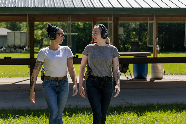 two women laughing walking together