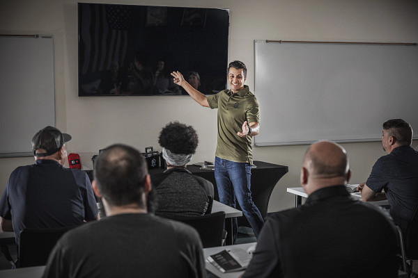 man teaching 5 students