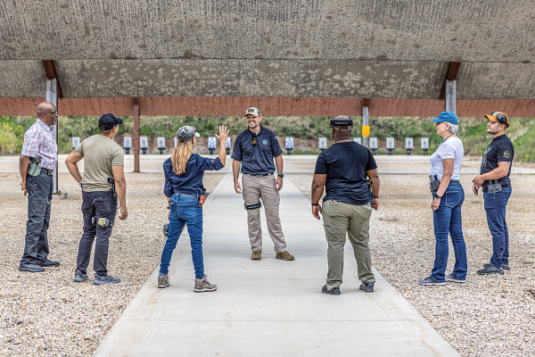 6 younger people standing around their instructor